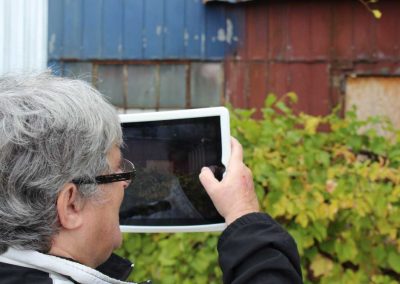 H'art artist taking a photo of a barn with iPad