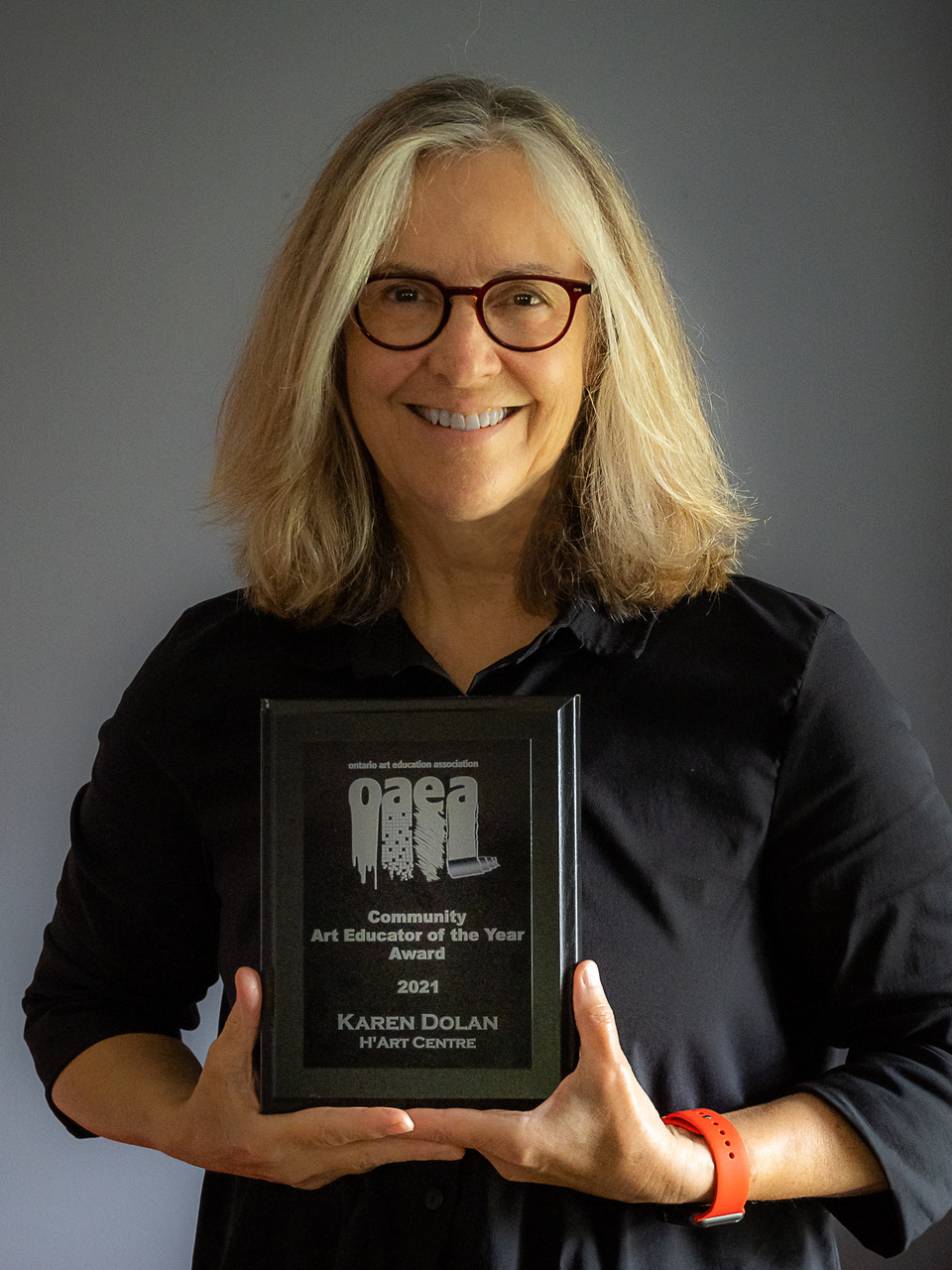 Karen Dolan holding the award plaque